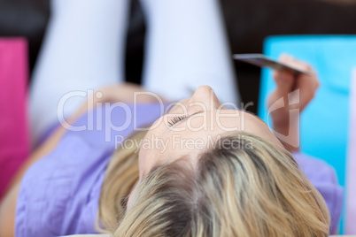 Close-up of a woman holding a credit card after shopping