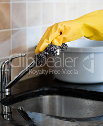 Close-up of a person cleaning a kitchen