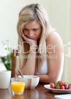 Tired woman having an healthy breakfast
