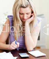 Stressed woman paying her bills