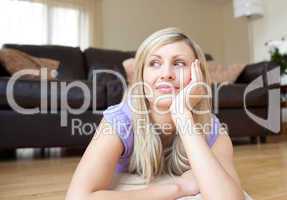 Young blond woman lying on the floor