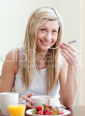 Happy woman having an healthy breakfast