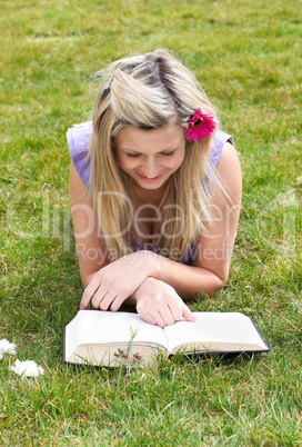 Young woman reading a book in a park