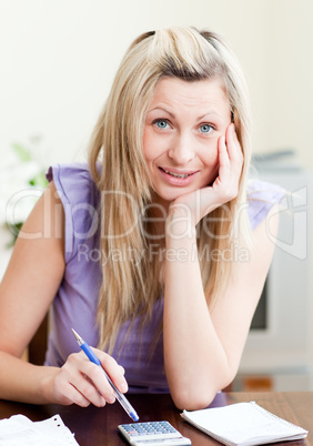 Portrait of a cheerful woman paying her bills