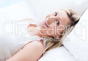 Attractive young woman lying on a bed