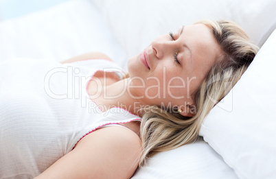 Beautiful young woman sleeping on a bed