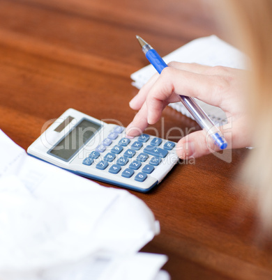 Close-up of a blond woman paying her bills