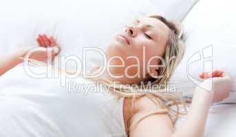 Relaxed young woman sleeping on a bed
