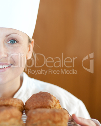 Close-up of a smiling female chef baking scones