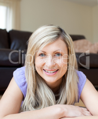 Laughing young woman lying on the floor