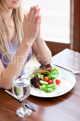 Portrait of a cute woman eating a salad