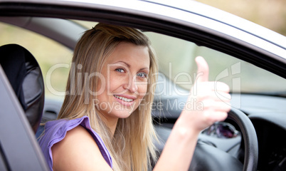 Smiling female driver with thumb up