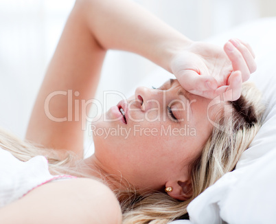 Tired woman sleeping on a bed