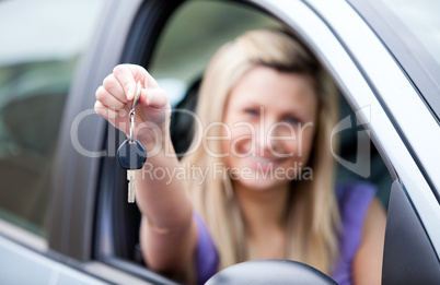 Young female driver holding a key