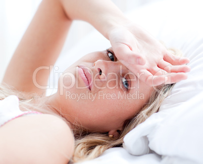 Sick woman lying on a bed