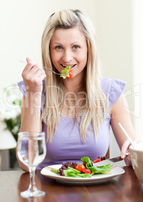 Portrait of a charming woman eating a salad