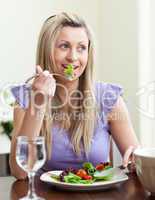Portrait of a jolly woman eating a salad