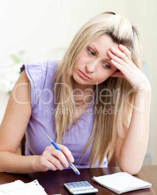 Stressed woman paying her bills