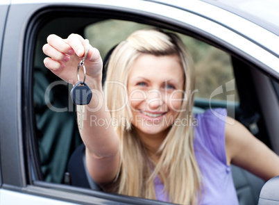Enthusiastic young driver holding a key after bying a new car