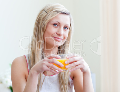 Portrait of an attractive woman drinking an orange juice