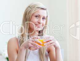 Portrait of an attractive woman drinking an orange juice
