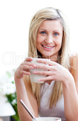 Portrait of a smiling young woman drinking a coffe