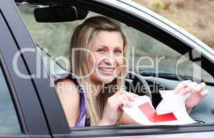 Jolly young female driver tearing up her L sign