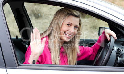 Joyful young female driver at the wheel