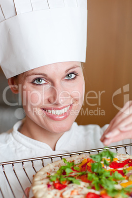 Radiant female chef cooking a pizza