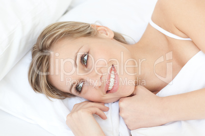 Radiant relaxed woman lying on her bed