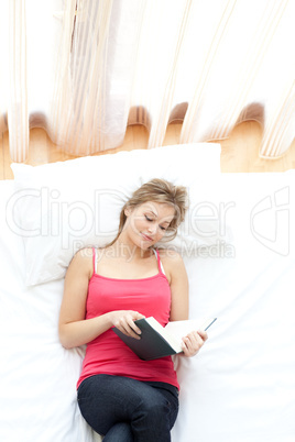Relaxed woman reading on her bed