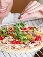 Close-up of a female chef preparing a pizza