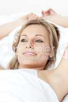 Charming woman relaxing  lying on a bed