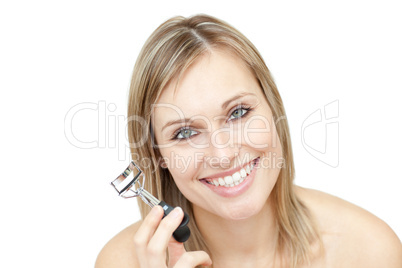 Cheerful woman holding an eyelash curler