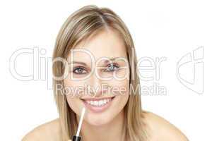 Delighted woman putting gloss