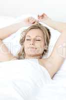 Relaxed woman sleeping on a bed