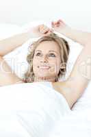 Radiant woman relaxing  lying on a bed