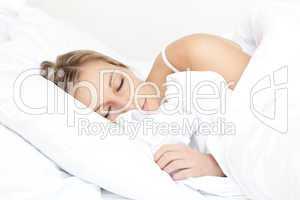 Beautiful young woman sleeping on her bed