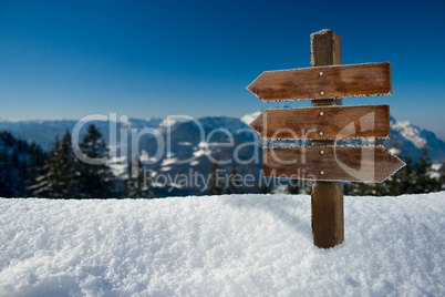 panorama of the alps with a wooden sign