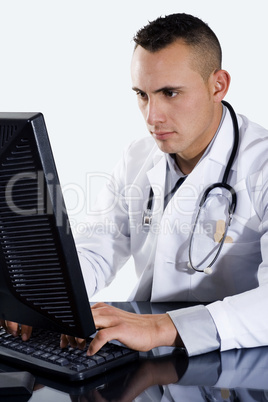 Male Doctor typing on computer