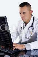 Male Doctor typing on computer