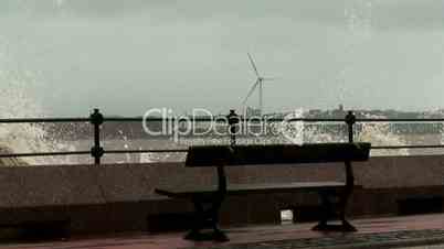 Stormy waves on the river with wind turbines in the background 4