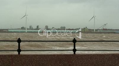 Stormy waves on the river with wind turbines in the background 5