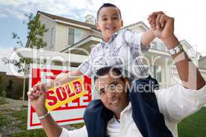 Hispanic Father and Son in Front of Their New Home
