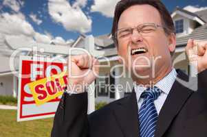 Excited Man in Front of Sold Real Estate Sign and House