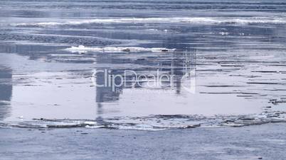 Ice drift and skyscraper reflection.
