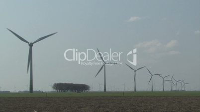 A large group of windmills rotating in the wind