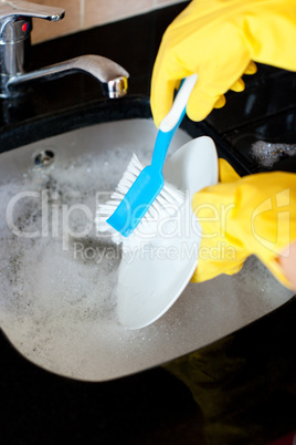 Close-up of a woman doing the dishes