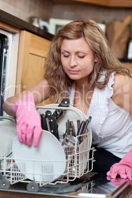 Young woman using a dishwasher