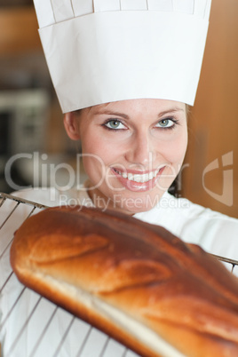 Cheerful female chef baking bread